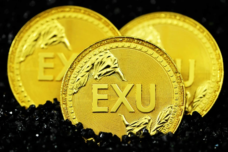 two gold exus are shown against black gravel