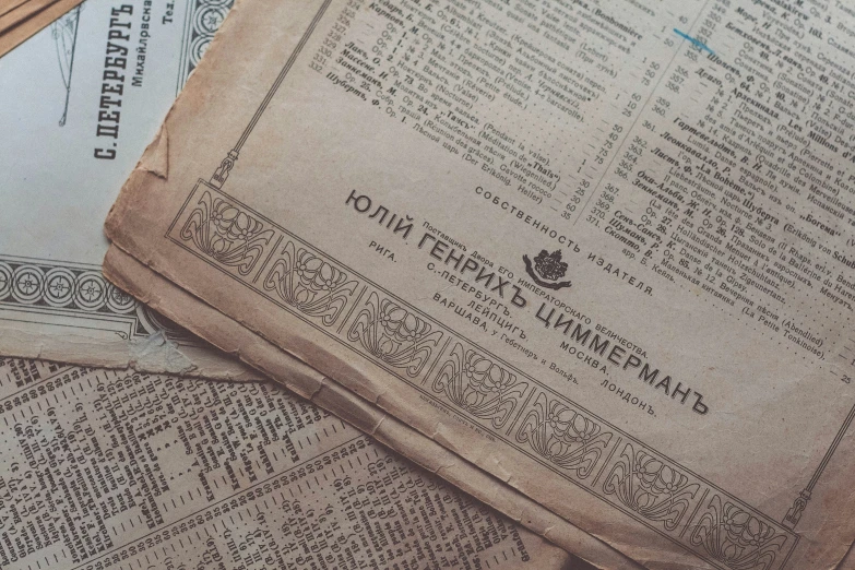 some newspaper are folded over on the table