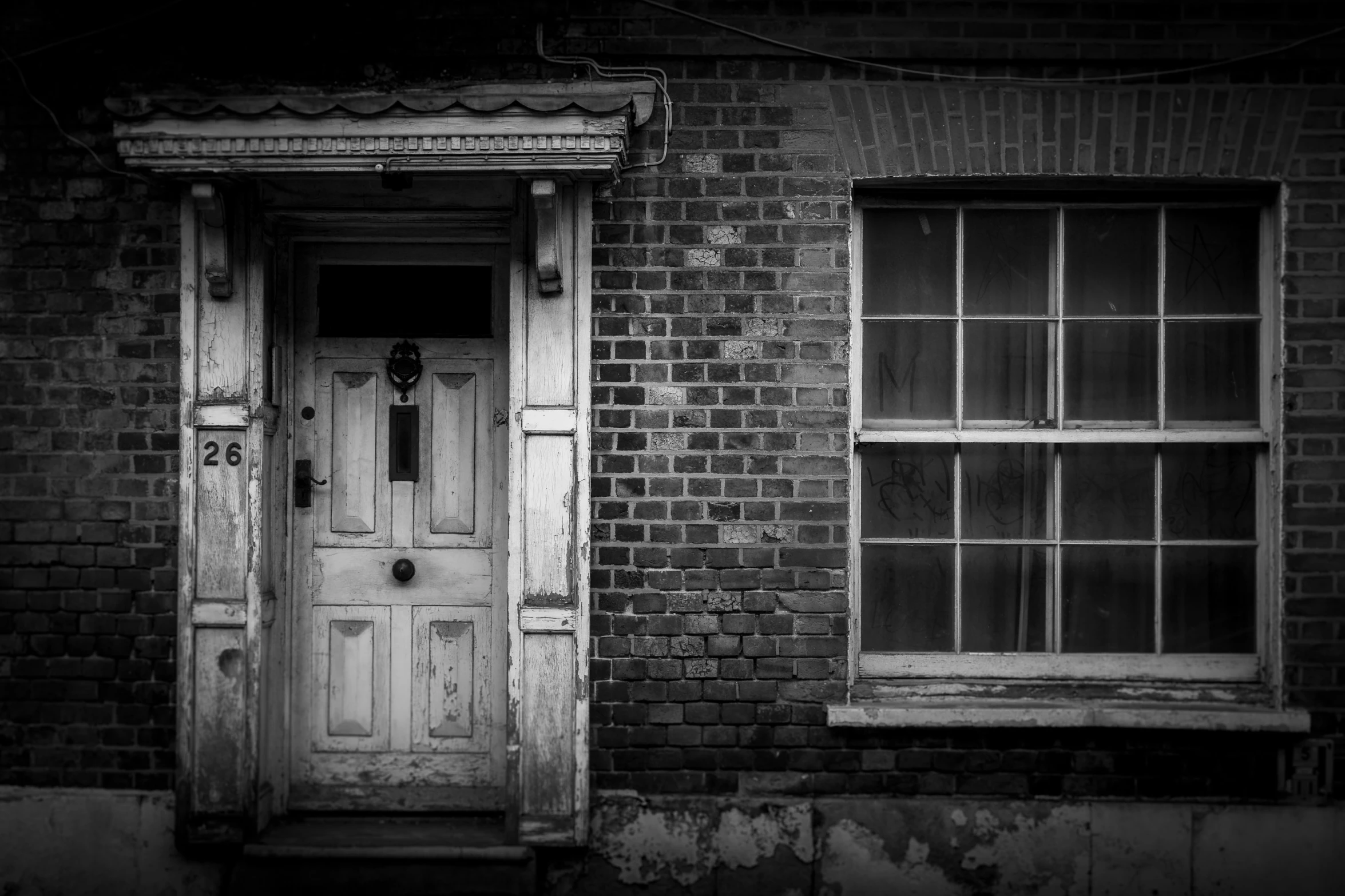 an old building with two doors and window panes