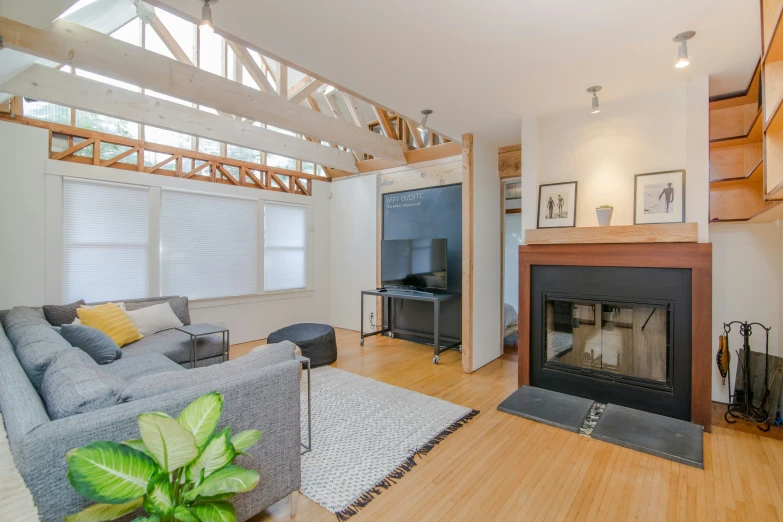 an open living room with fireplace and vaulted ceiling