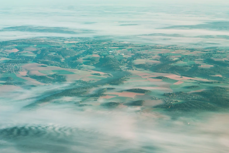 a picture taken from an airplane over some fields and mountains