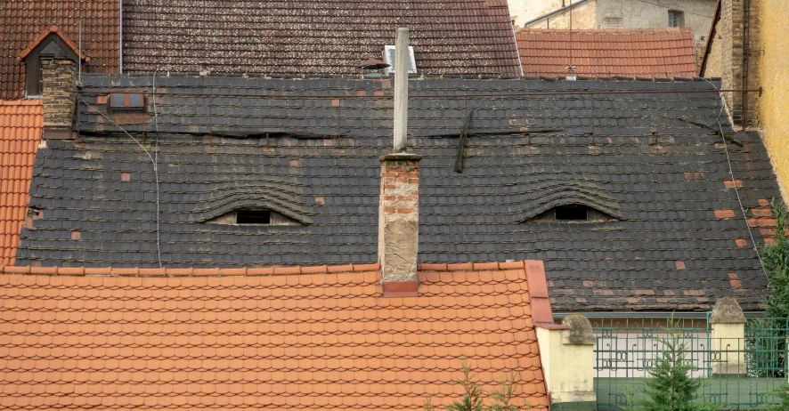 roof of houses with windows and a street sign