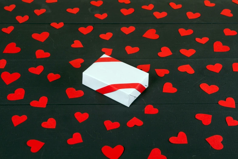 there are red hearts flying around a paper box