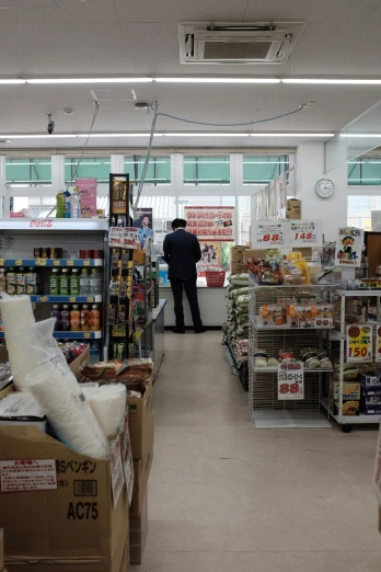a man in a store with shelves full of food