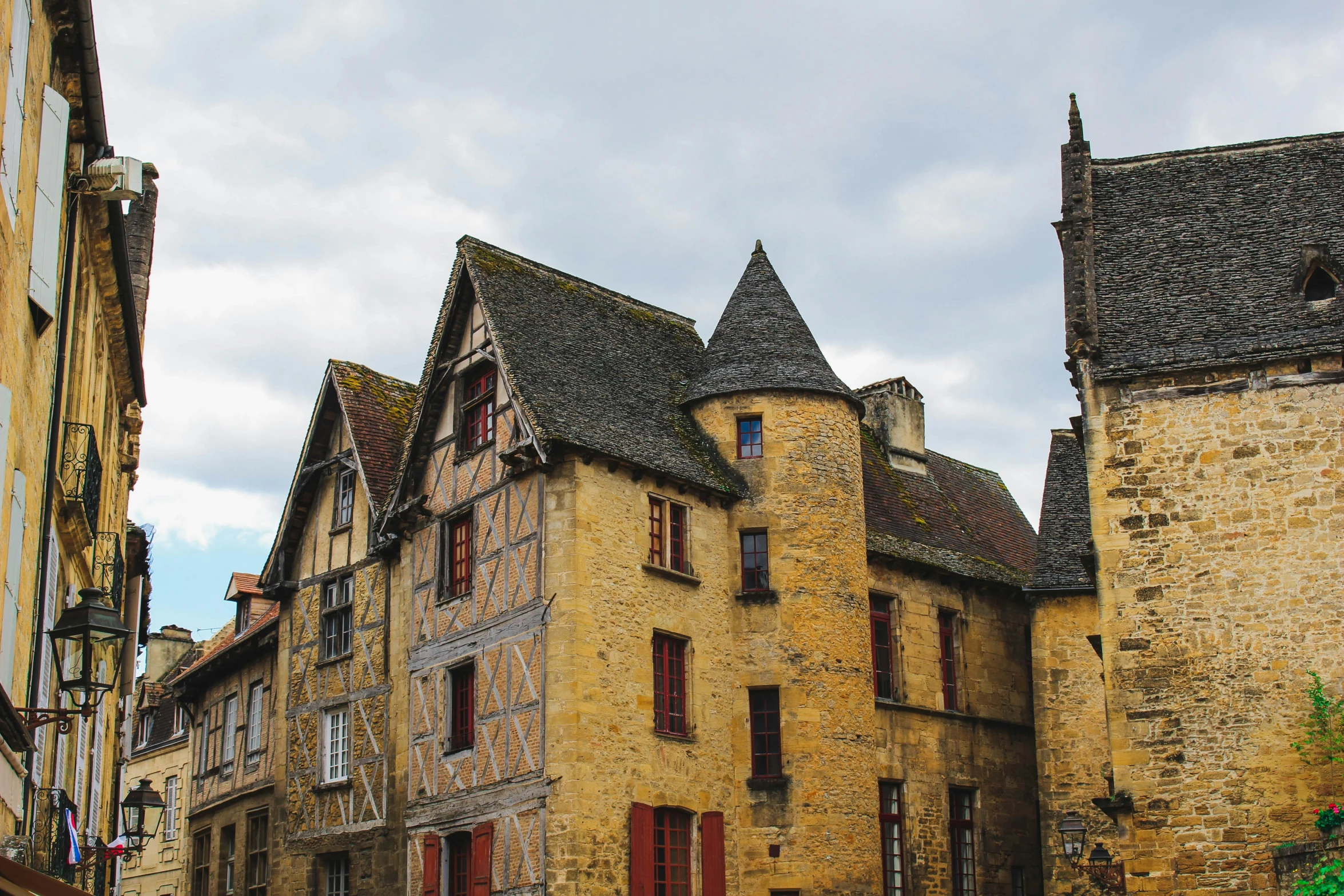 old houses line the street, with cobblestone buildings