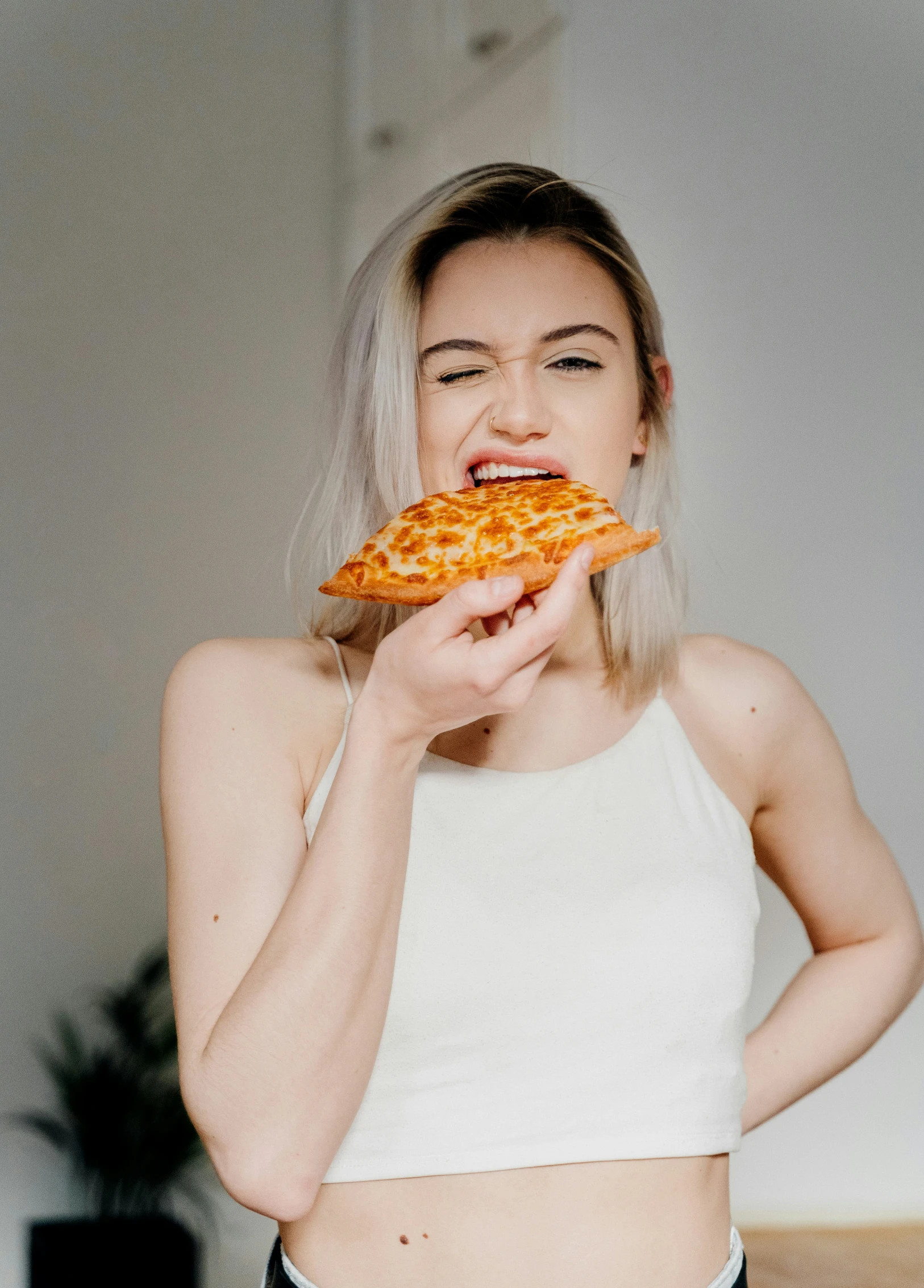 a  biting into a piece of pizza