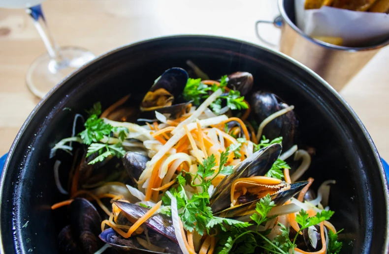 steamed mussels in a bowl on the table