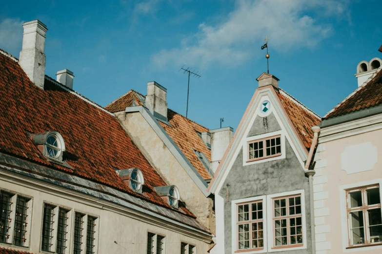 a street of old buildings with red roofs and chimneys