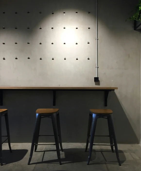 two stools and a long table in a room