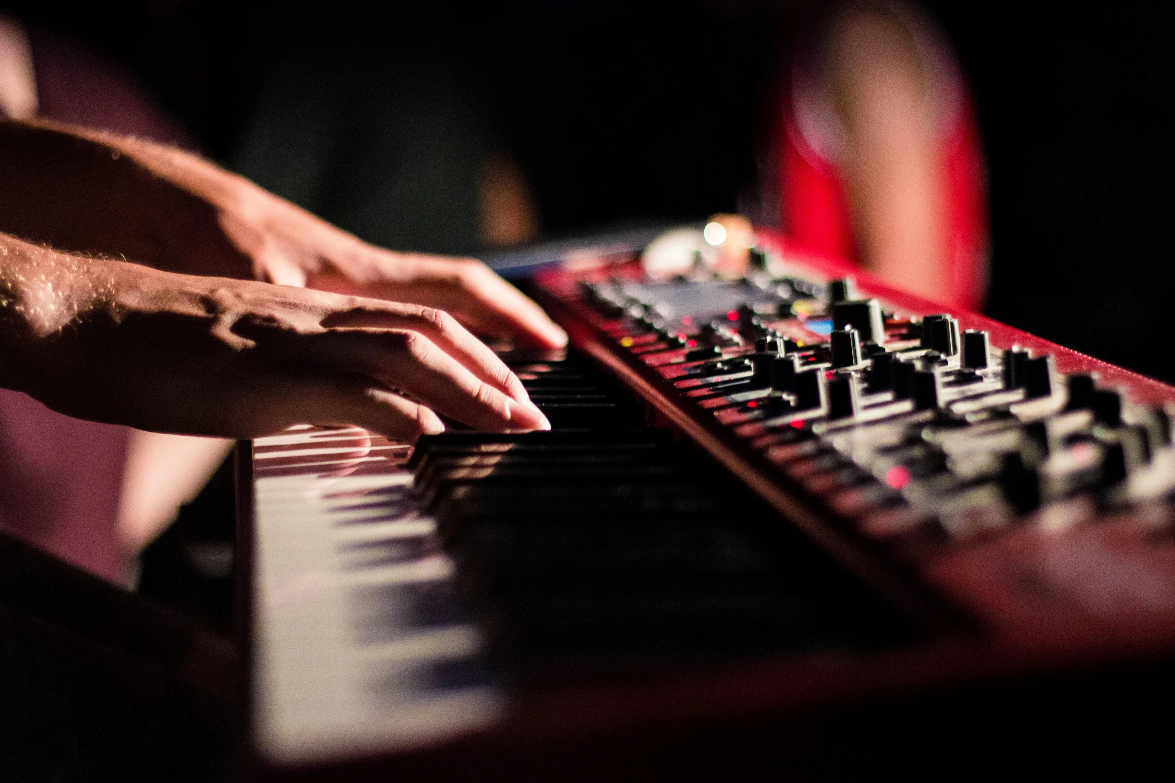 a person is playing on the electronic keyboard