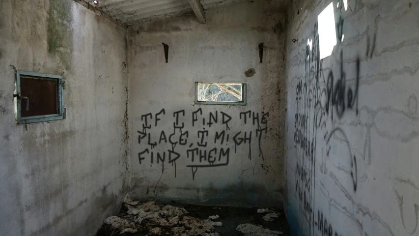 a small room with a graffiti covered wall