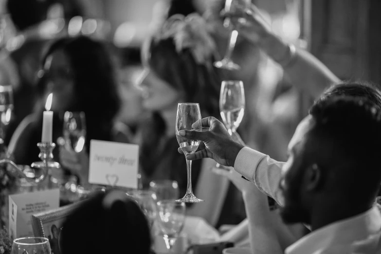 a group of people raising wine glasses in the air