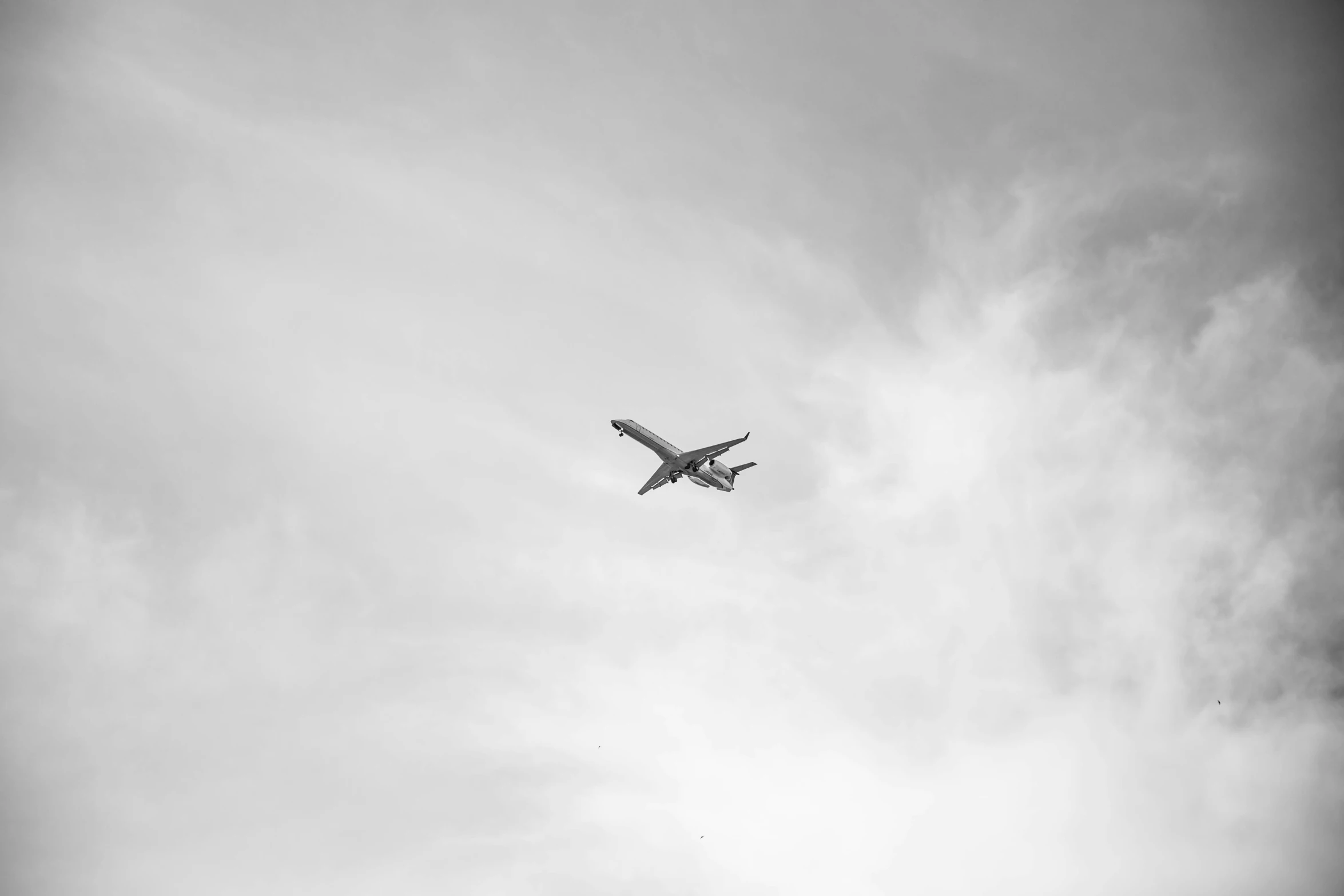 an airplane flying in the sky with clouds