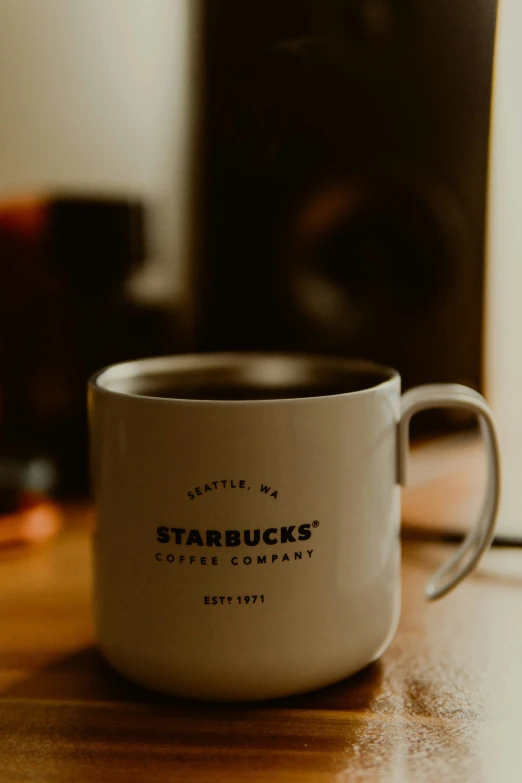 there is a starbucks cup on the table