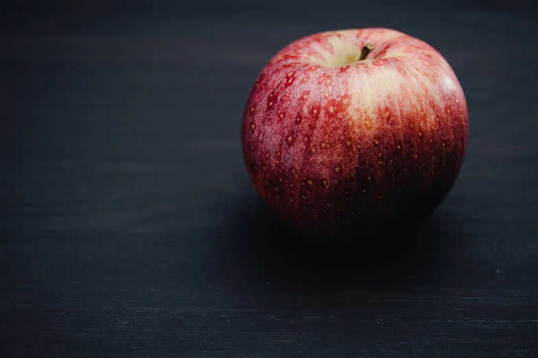 the bright red apple looks very pigment and stands upright