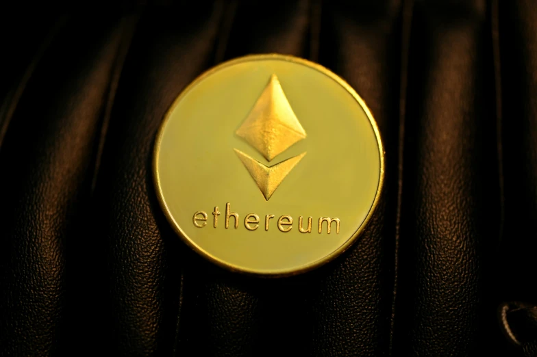 a gold plated ethereum on on a black surface