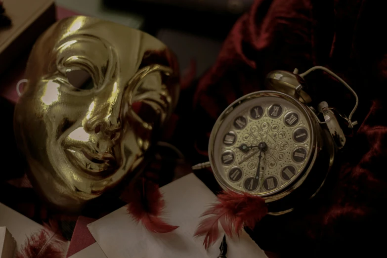 a mask on the background of a gold alarm clock