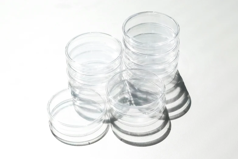 stacks of transparent glass jars with white background