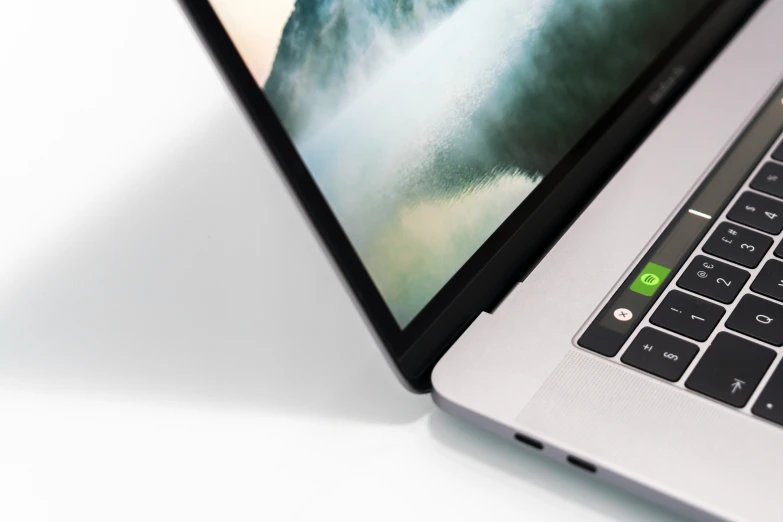 an open laptop computer sitting on top of a white table