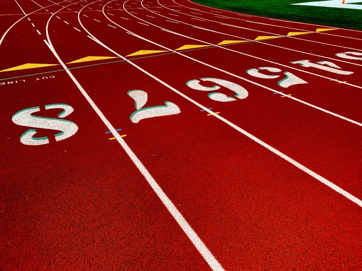 an empty running track on a grass covered field