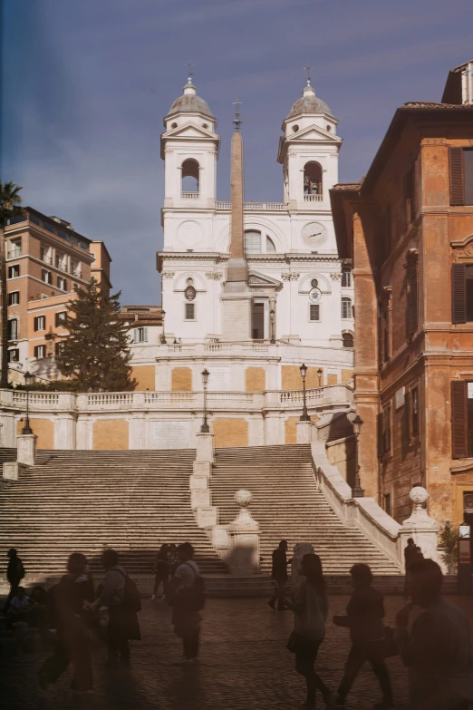 several people walking down the steps in front of a building