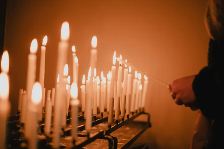 a group of white candles in front of a wall