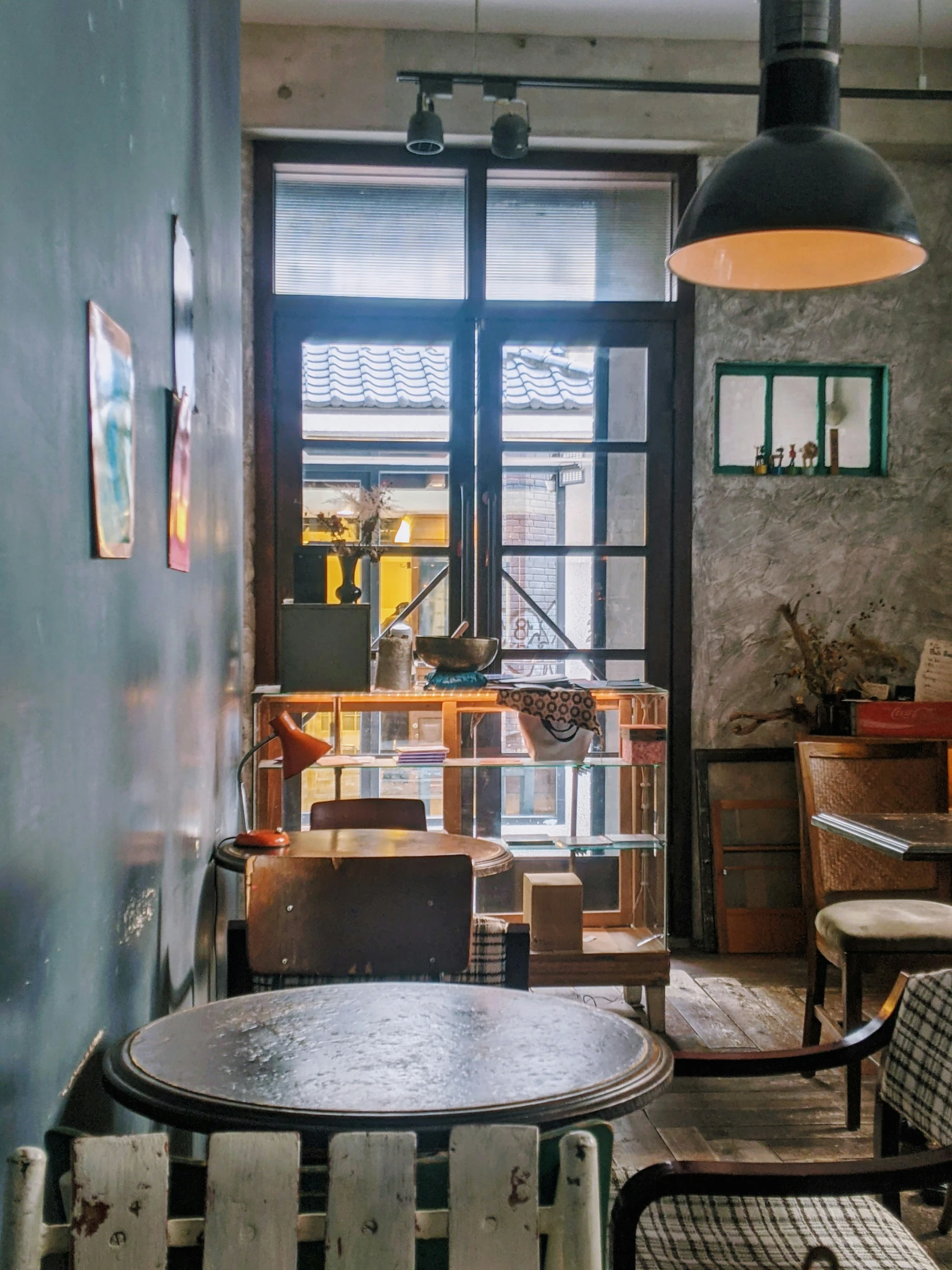 some chairs and tables near a wall