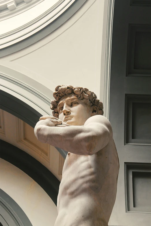 a white statue of a man with his arms behind his back