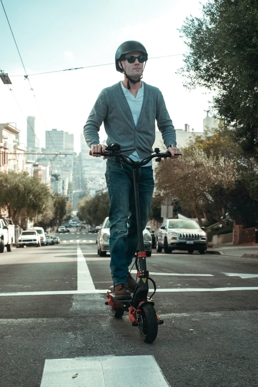 a man riding a scooter on the road