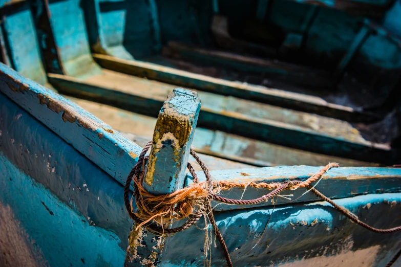 closeup of a rusty boat with roped up and some water damage