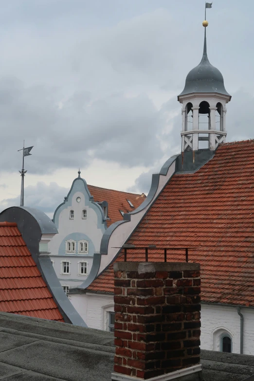 the roofs of buildings with a white and red building on one side