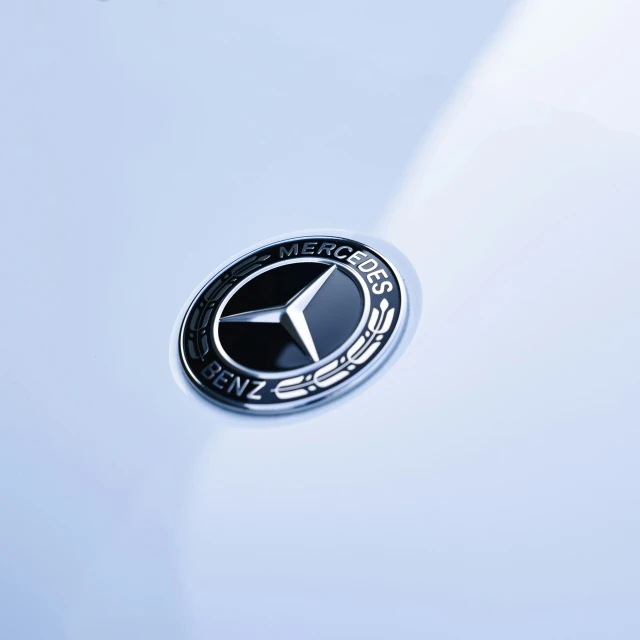 mercedes emblem on the front end of an automobile