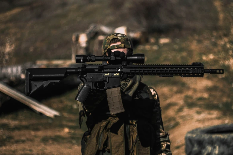 a soldier holding an m & p machine gun