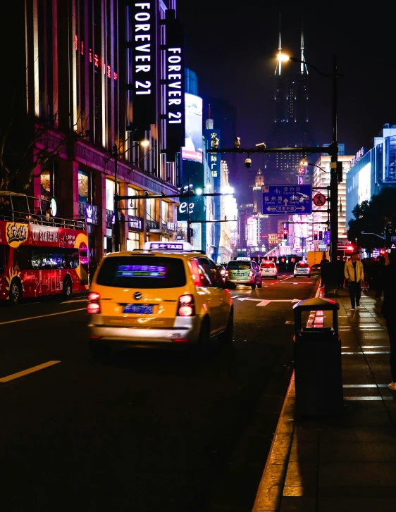 a car going down the street at night time