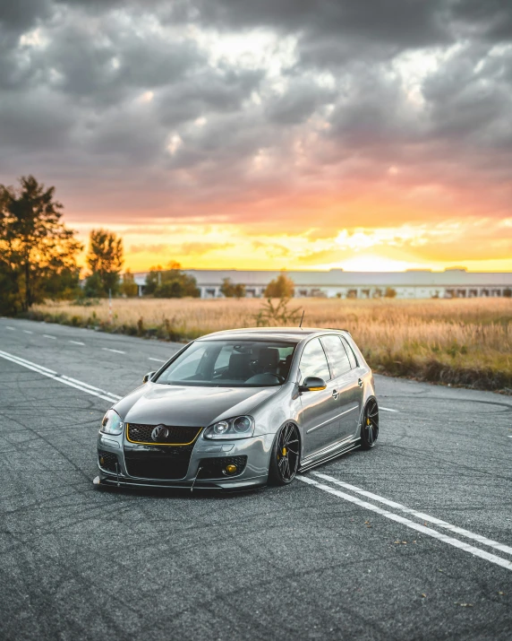 a car sits on the side of a highway under a cloudy sky