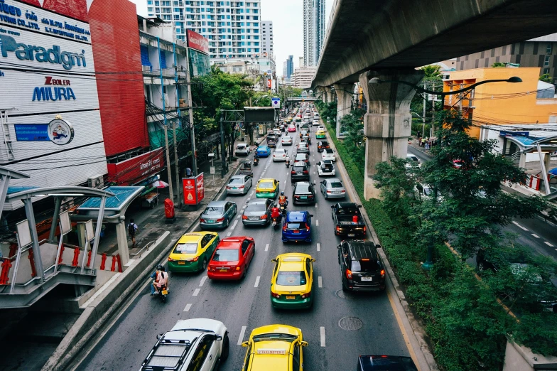 a street with many vehicles in traffic and tall buildings