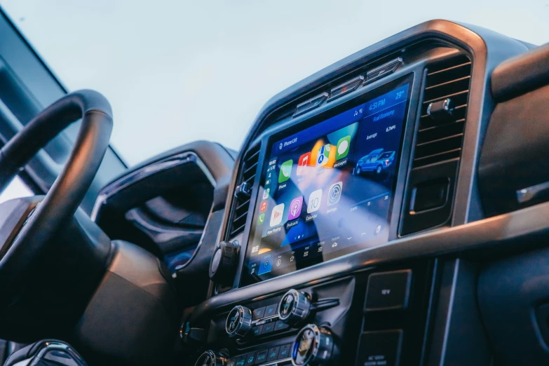 a close up of a cell phone in the center of a vehicle