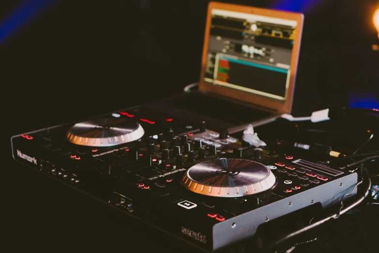 a laptop and dj mixer on a table