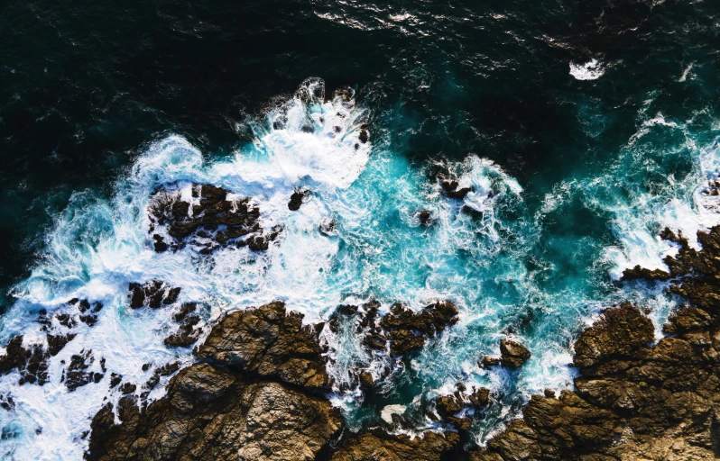 water coming from an ocean on the rocks