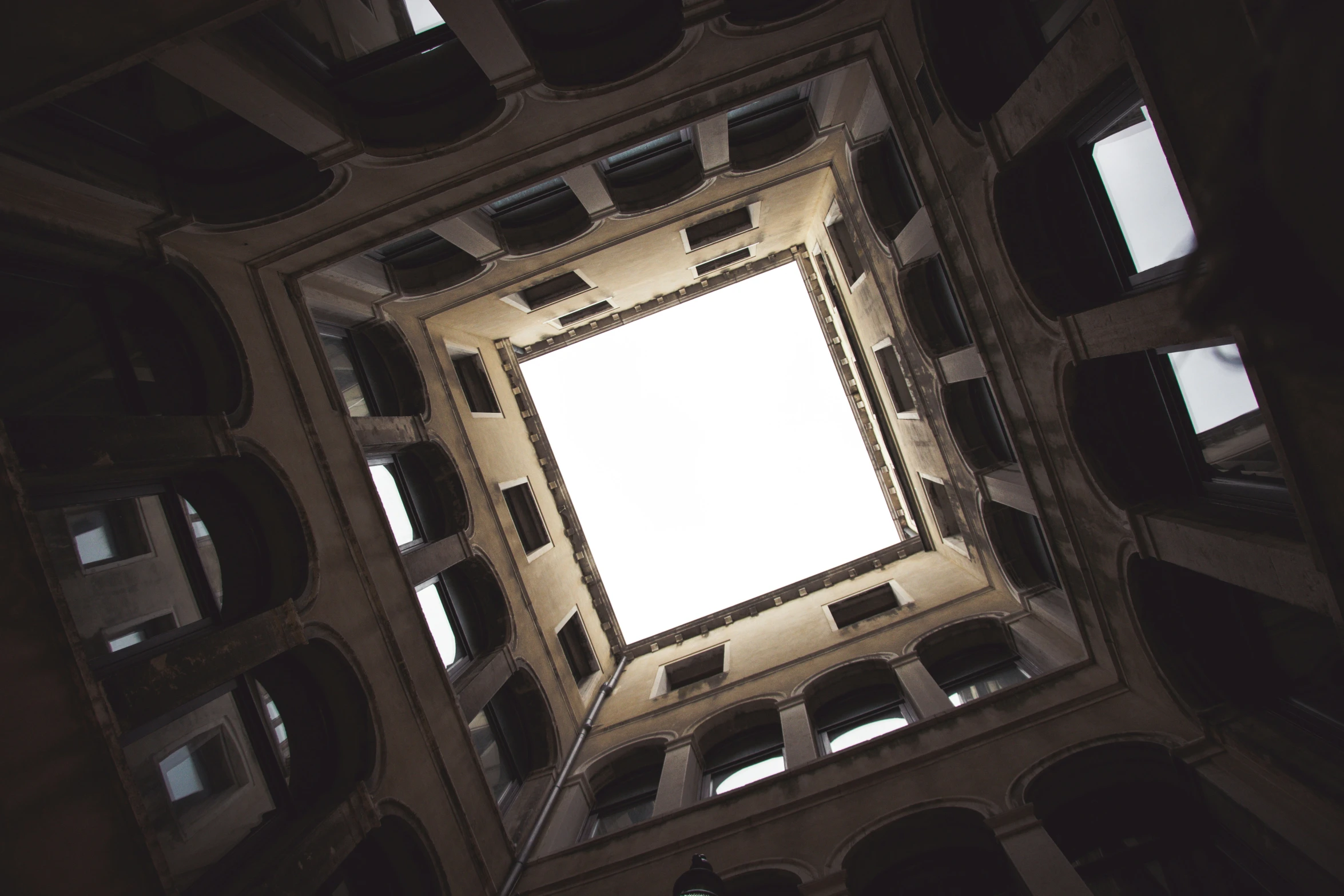 view up the center of a geometric ceiling