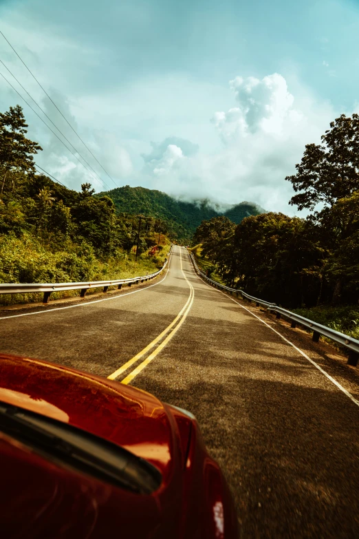 view from the driver of a car traveling down an open road