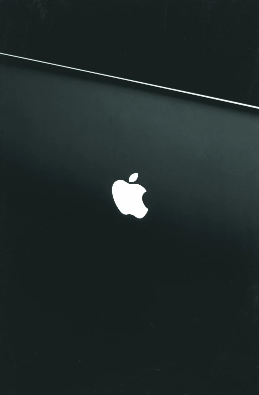 an apple computer is pographed close up in black and white