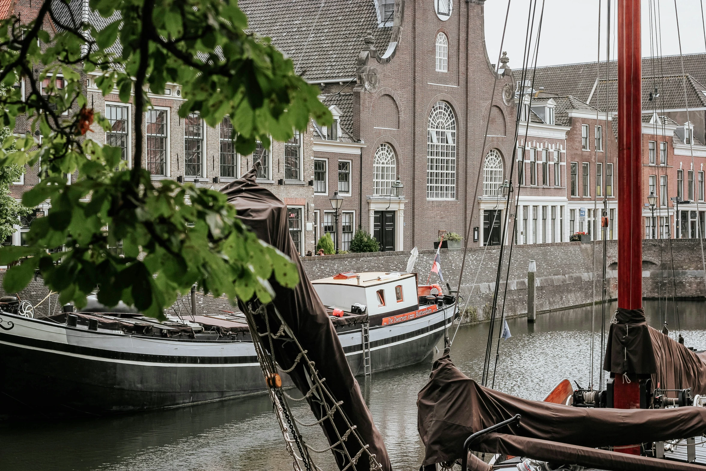 a boat docked in the water near houses