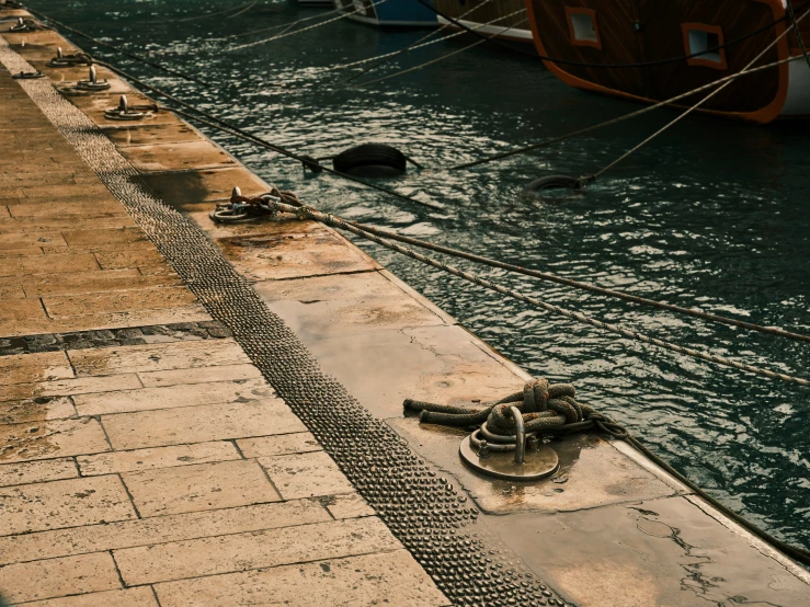 the anchor line is near the boat dock with ropes