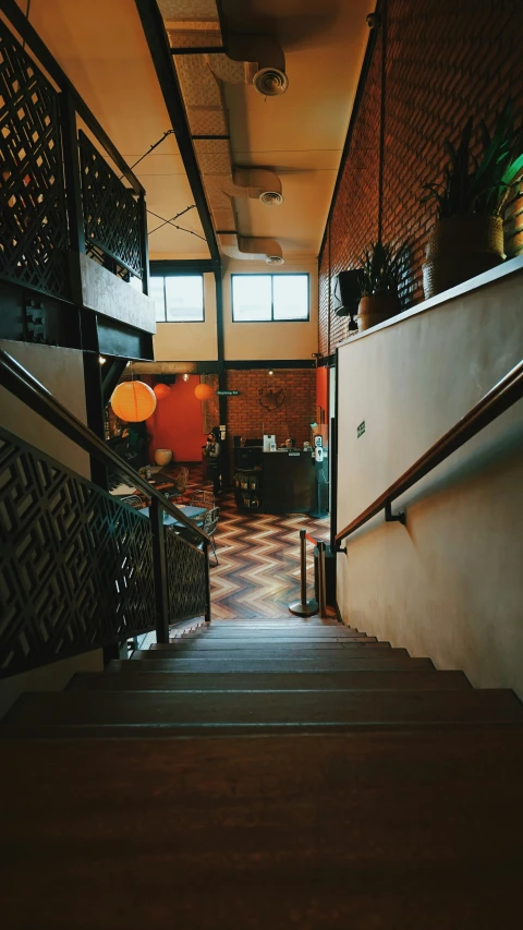 an entryway leading to a stairway with a potted plant in the corner