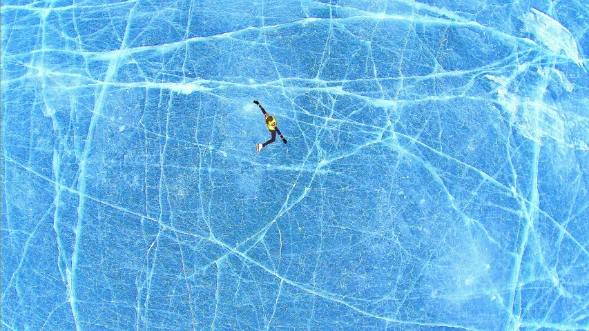 the figure is floating on an ice skating rink