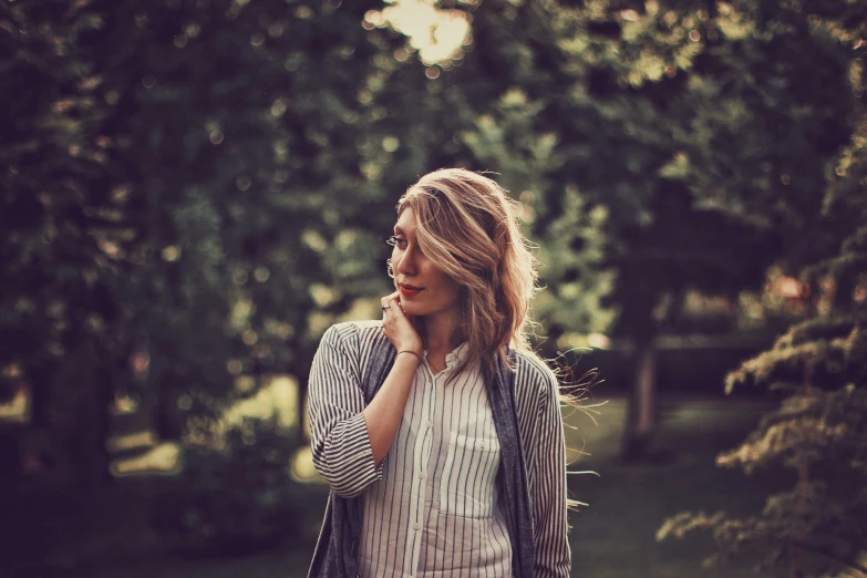 a girl looking away from the camera while wearing a scarf