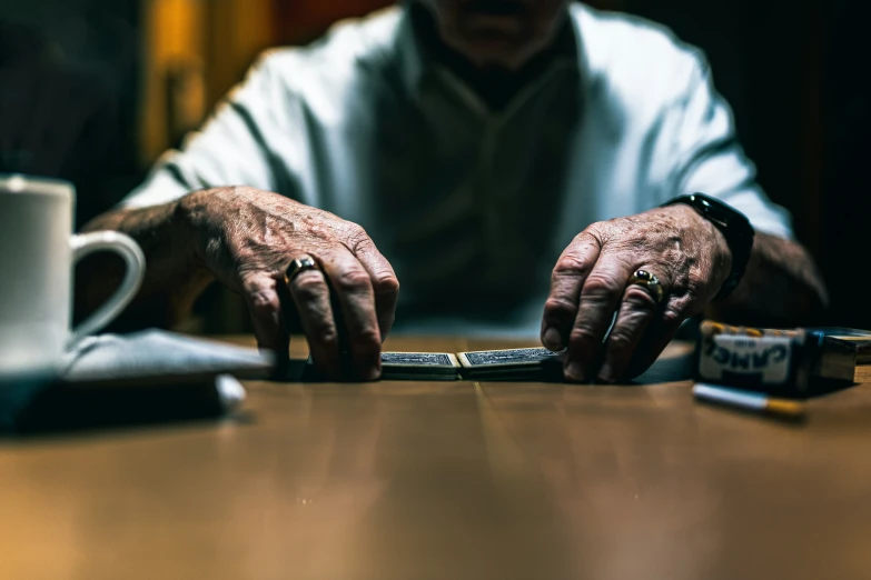 a close up of an old person typing on a tablet computer