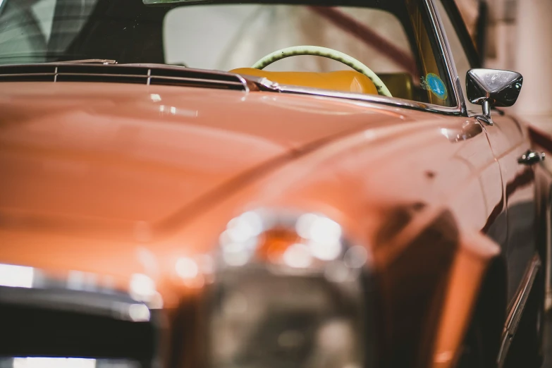 an orange car is parked in a garage