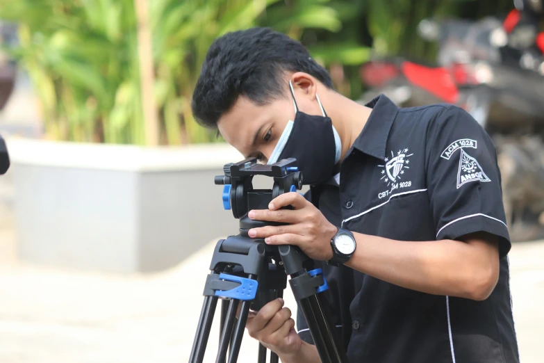 a man is in his cell phone while filming